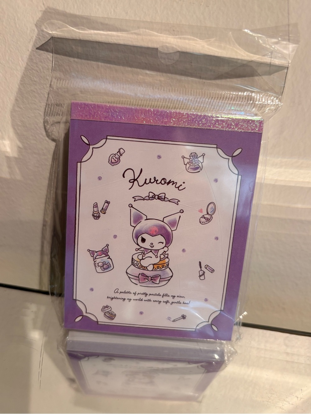 Mini kuromi notebook notepad, iridescent purple design at top.